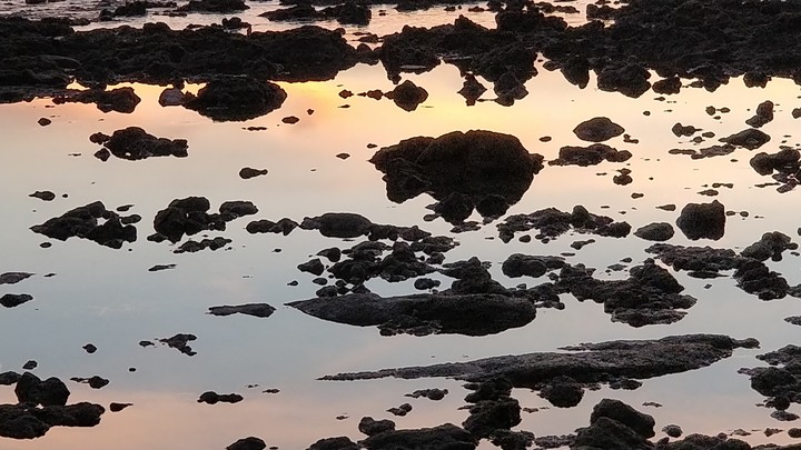 Tides reveille's the rocks doring sunset