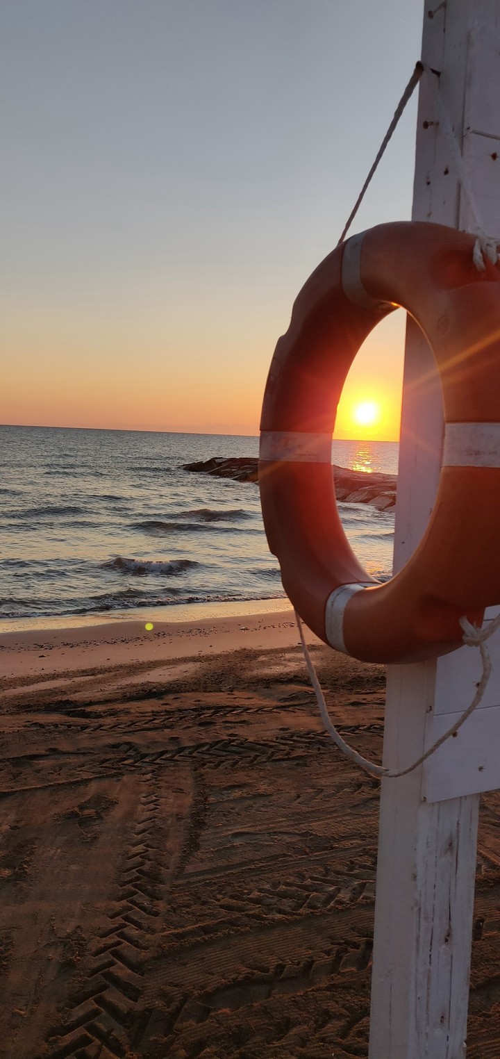 sun rising behind a float