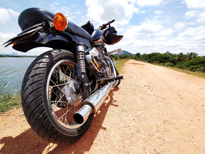Two tyres, clear sky and open road