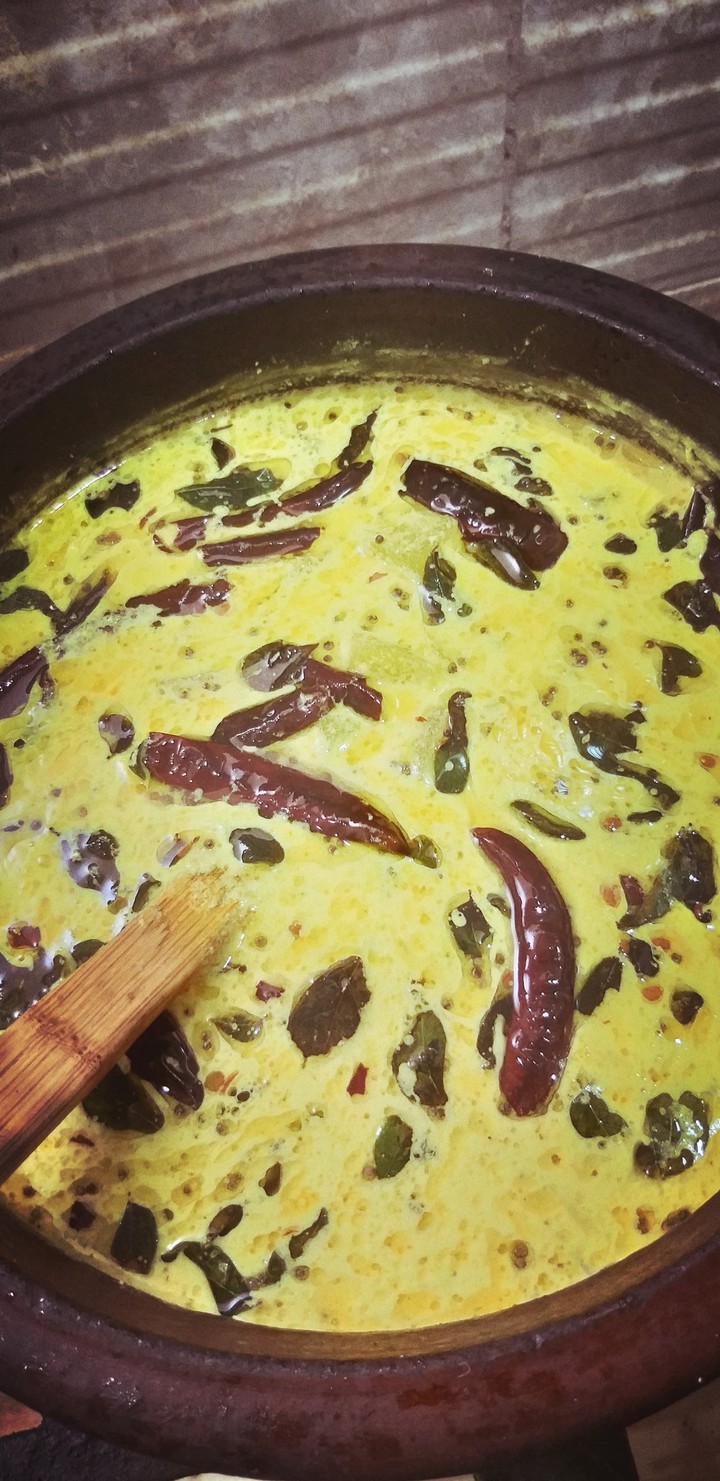 my friend cooking moru curry