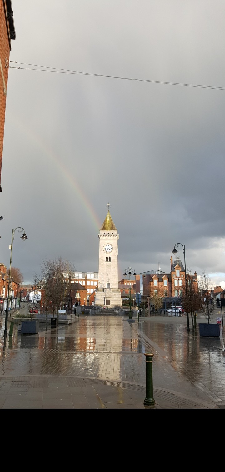 clock tower and rainbow