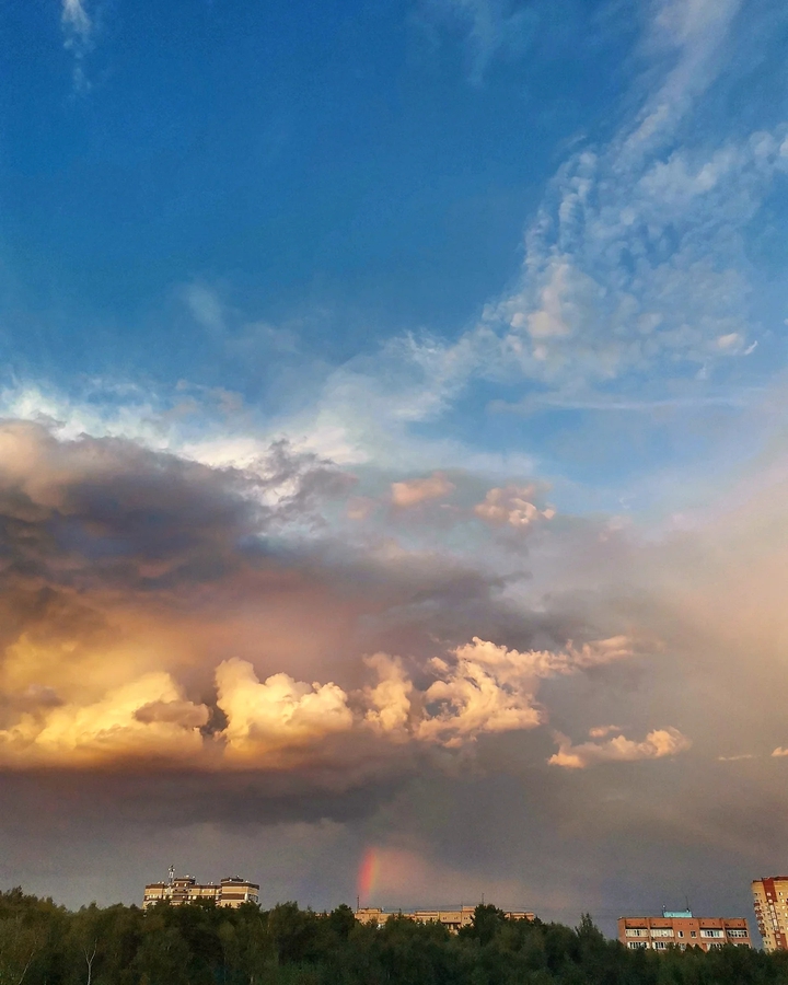 rainbow under clouds
