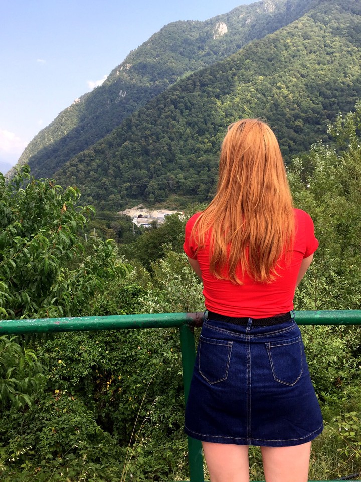 unknown girl looking at the mountains