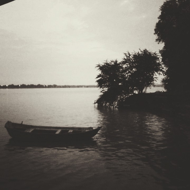 Boat beside riverside.